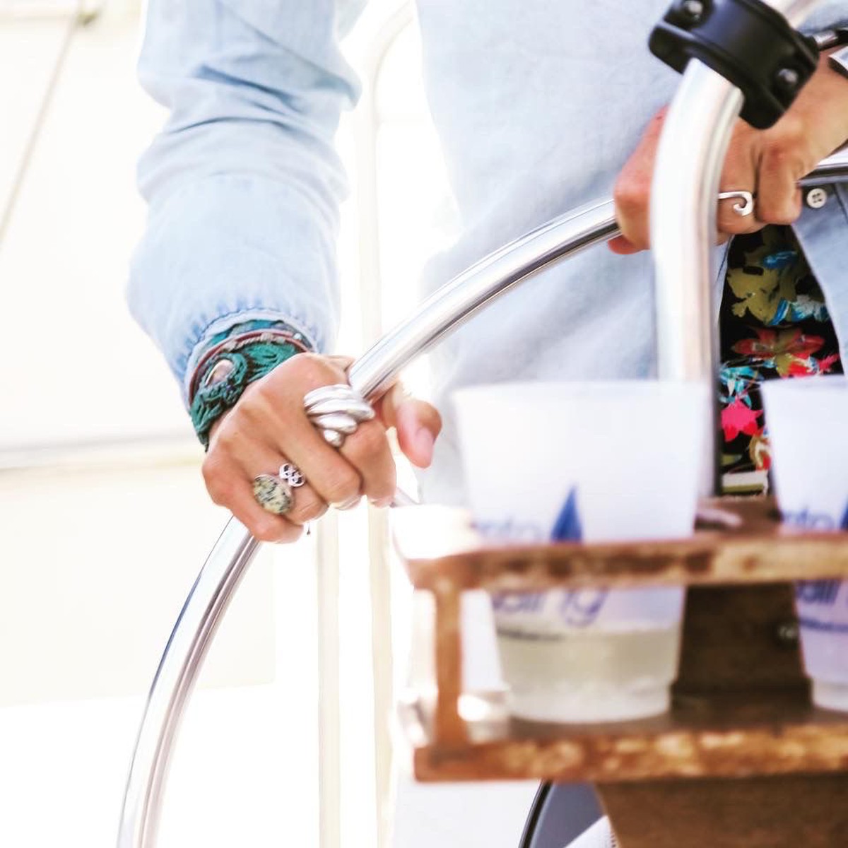 A Maritime Gal's hands steering the wheel underway